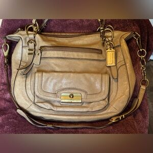 Coach handbag beige with gold accents.